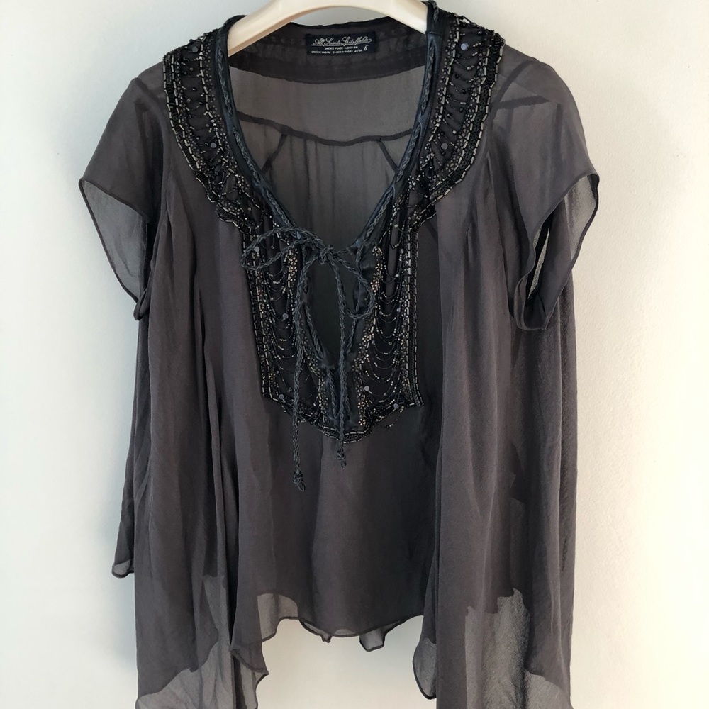 Ethereal yet edgy top with beaded embellishments.